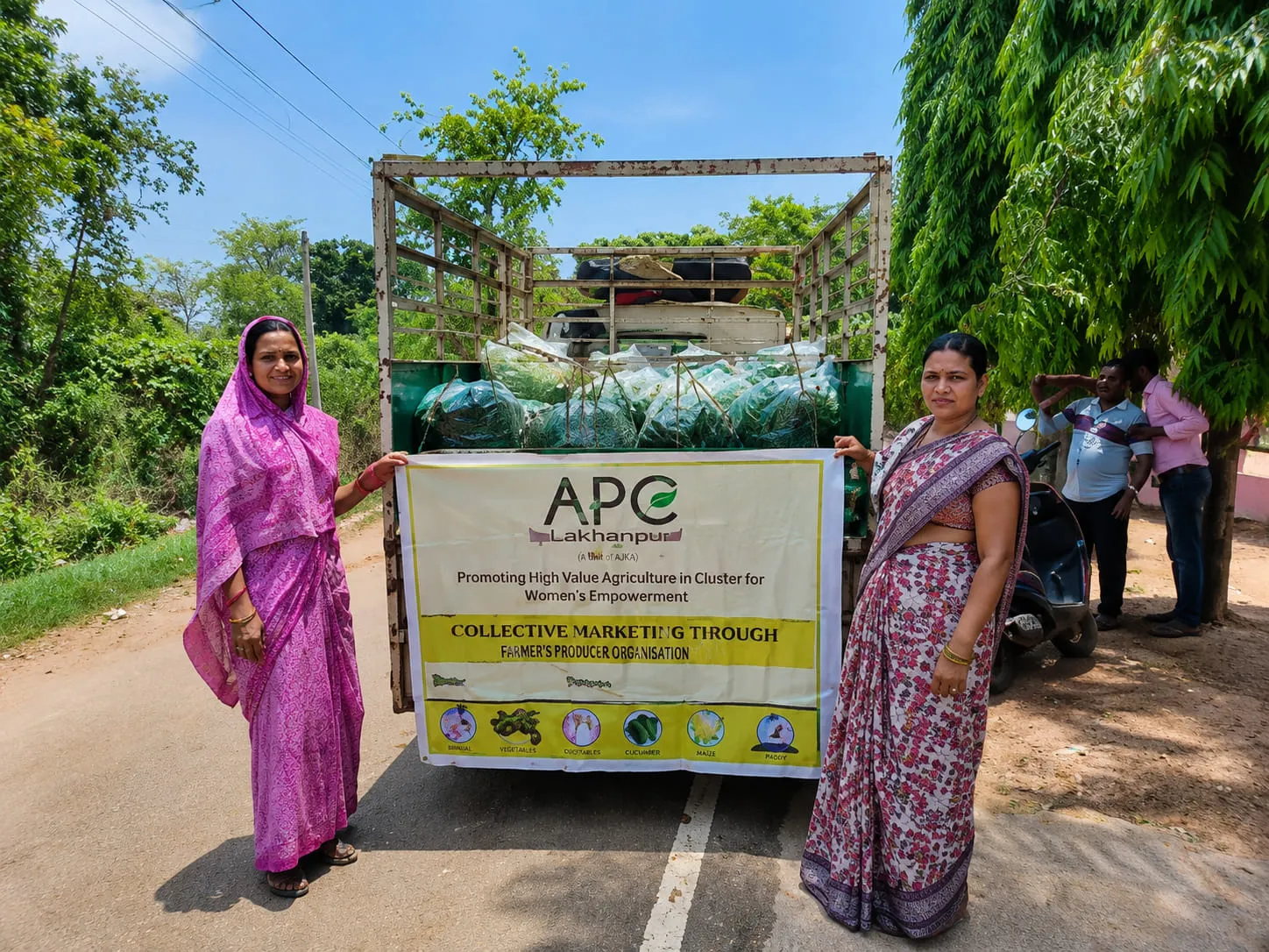 Members of the Omm Sai Producer Group with the APC collective marketing banner, loading produce for sale
